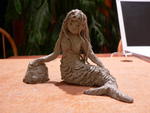 A clay mermaid. . .